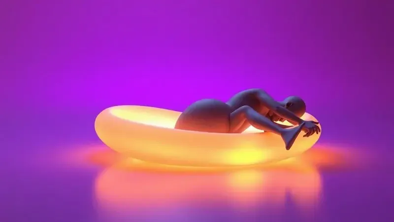 Silhuetas estilizadas em 3D de um casal em repouso sobre uma superfície ergonômica com iluminação dourada.